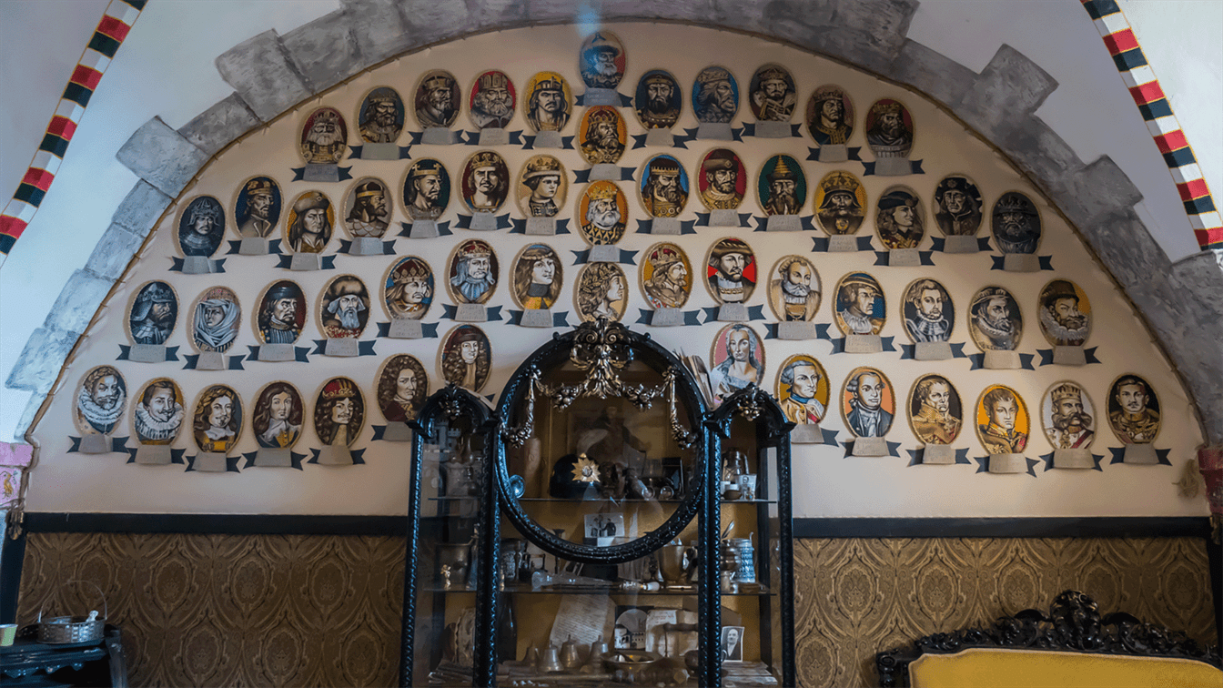 a display case  and in the background there is a wall containing a painted genealogy chart